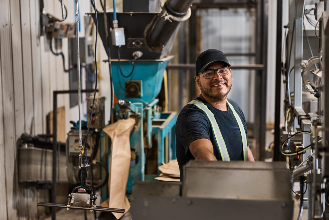 Man working in a Saskatchewan packaging facility, preparing wholesale food products for distribution.