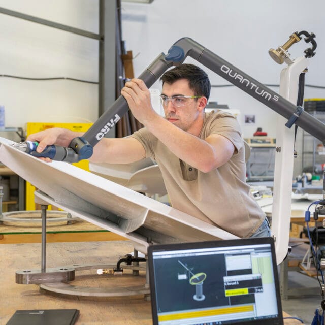 Aerospace and defence image of man working on a satellite