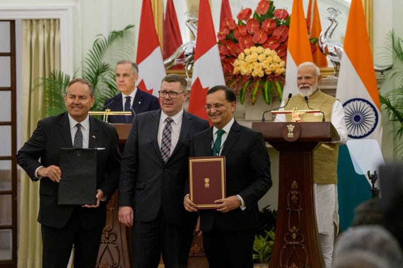 Premier Scott Moe stands with Cameco President and CEO Tim Gitzel and Indian High Commissioner to Canada Dinesh Patnaik at a signing ceremony for a $2.6 billion agreement between Cameco and India’s Department of Atomic Energy, which will supply Saskatchewan uranium to India over the next nine years.