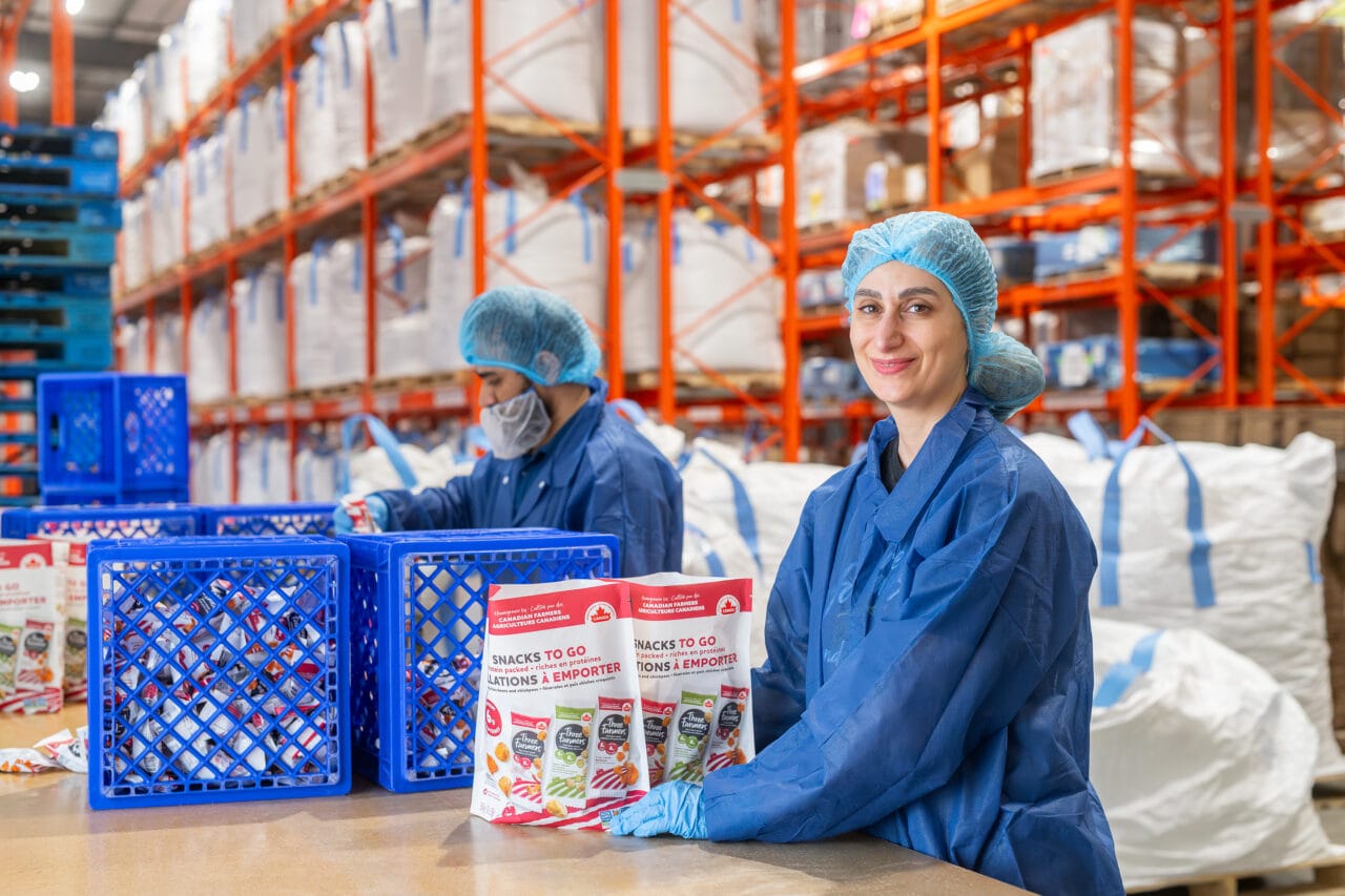 Industrial processor operating in an agricultural value warehouse, packaging goods for distribution in a production environment.
