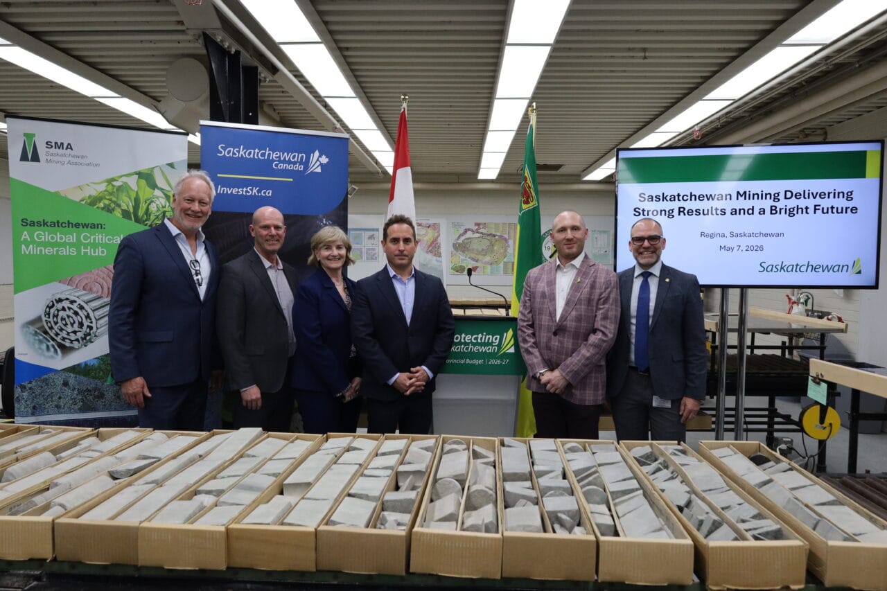 Saskatchewan political leaders pose for a photo infront of mineral samples.