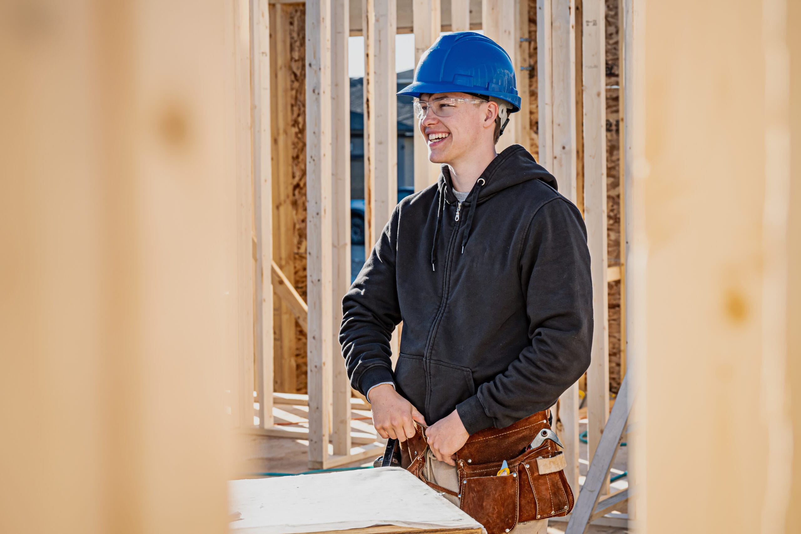 A man in safety equipment works on a construction site.